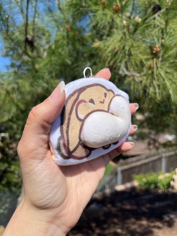 The same thing but tilted to better show the stuffed part of the flat keychain 