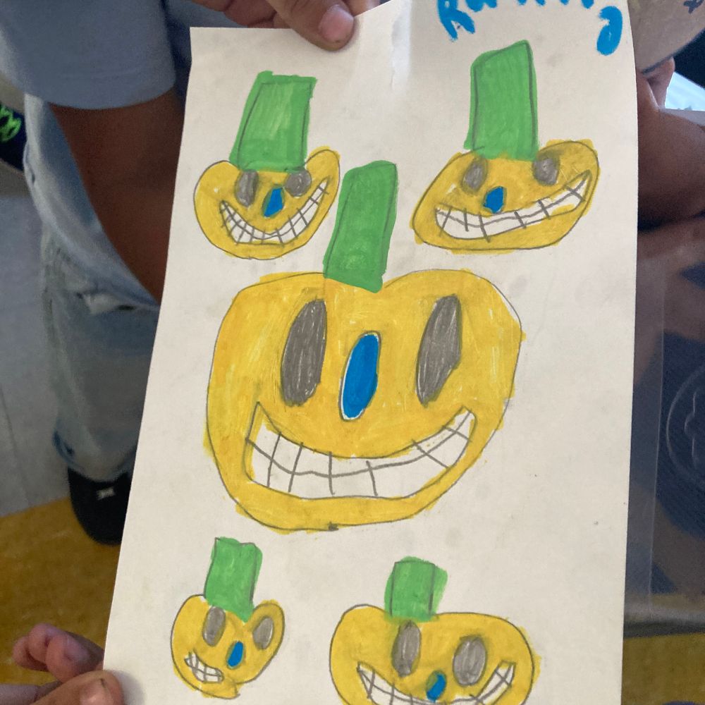Colorful drawing of five grinning pumpkins by a 2nd grader