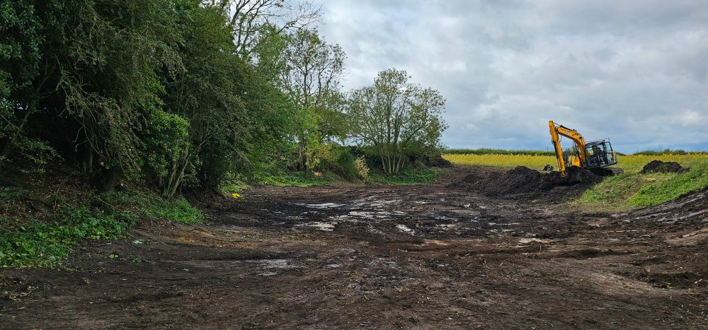 A pond being dug out showing streaks of marl