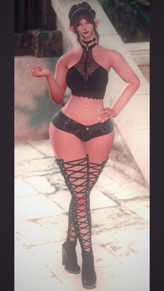 A fullbody shot of a female Elezen with purple and pink hair. It's in a messy updo and she has fringe parted in the middle with face framing pieces. She's standing sassily with one hand up and fingers curled in a loose fist, the other is at her hips. She's wearing a black lacy top, black leather shorts, and some thigh high boots with silver soles and hardware. The boots lace up at the front. Her nails are long and she has silver rings on her fingers.