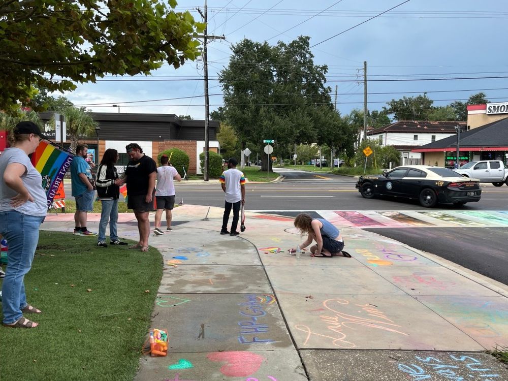 A squad of Florida Highway Patrol and Orlando Police Department officers surveilled the dozen people who were using chalk on the rainbow crosswalk on Sunday. Advocates said it was an intimidation t…