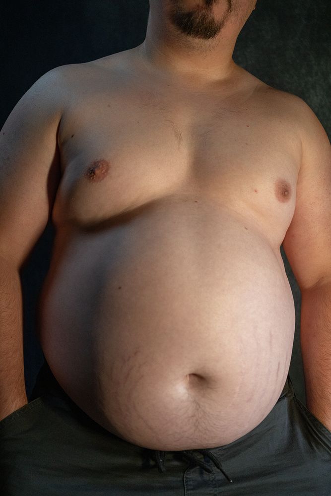 Babyblueboxers' belly, facing forward, leaning slightly to the right, his left