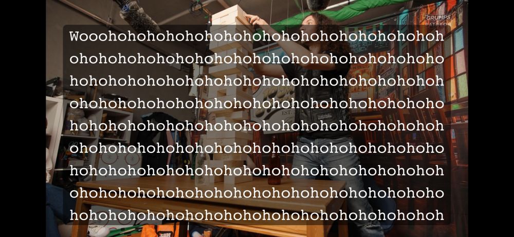 A screenshot from a game grumps ten minute power hour episode. It depicts Dan Avidan standing at a table, playing a game of giant jenga. The caption says “wooohohohohoho” for a very long time, covering nearly the entire image