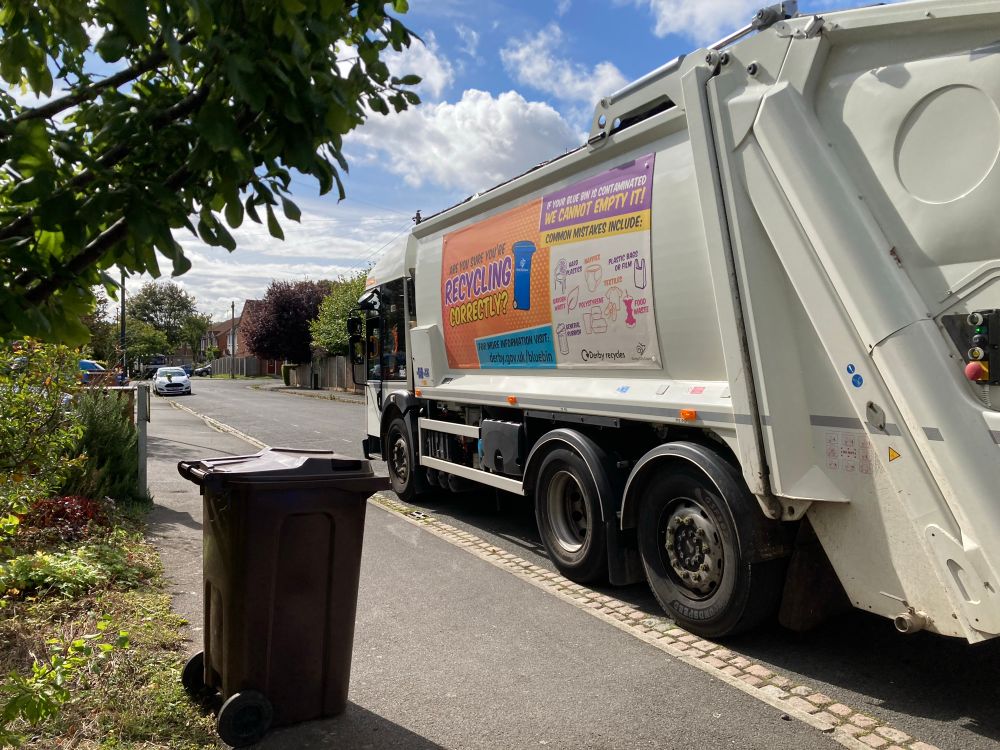 A low cab, direct vision recycling bin lorry on a residential street