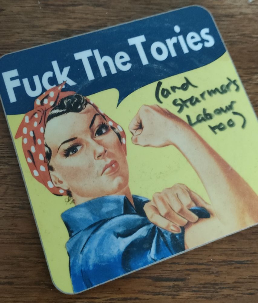 A coaster showing Rosie the Rivetter and the message "Fuck the Tories" and an added handwritten message "(and Starmer's Labour too)"
