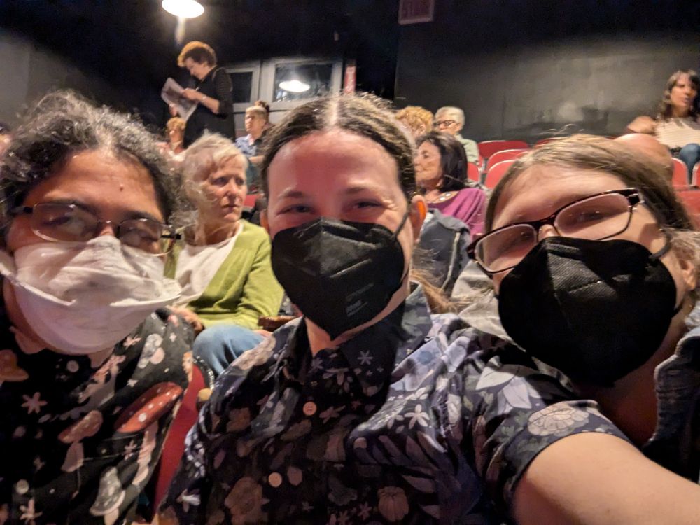 Susan, Faye, and Esa, wearing masks, with Faye taking the selfie