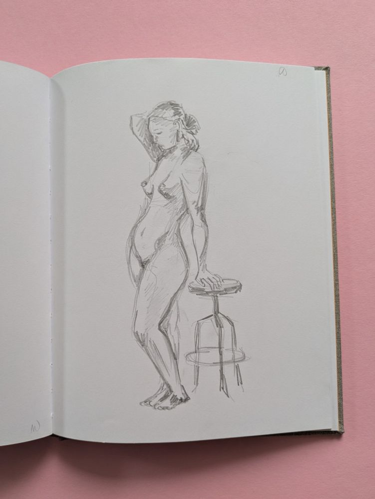 a pencil sketch of a naked woman standing and resting her hand on a stool that's behind her