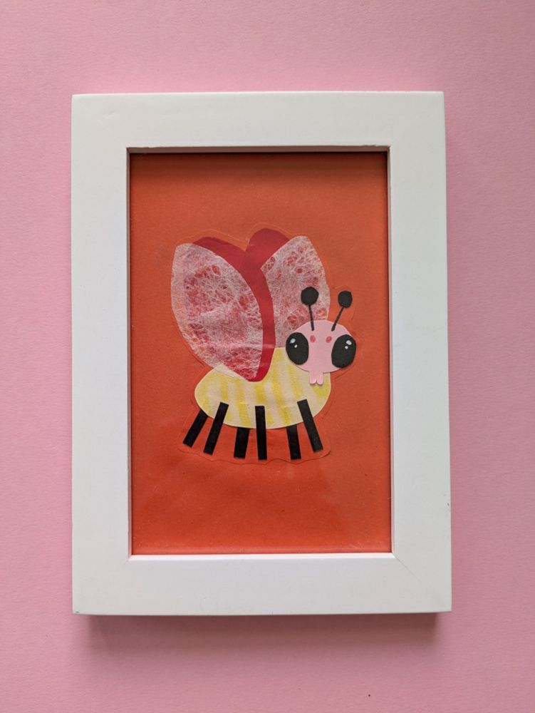 A collage of a bug in a picture frame. The bug is yellow and has 6 black legs. It has 2 red wings and 2 white see through wings. It looks straight at you with its black but glowing eyes. 