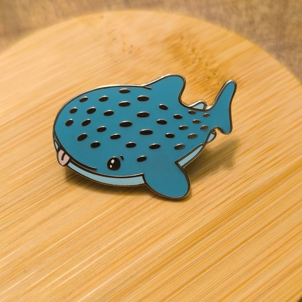 Cute hard enamel pin of a whale shark sticking out it's tongue 