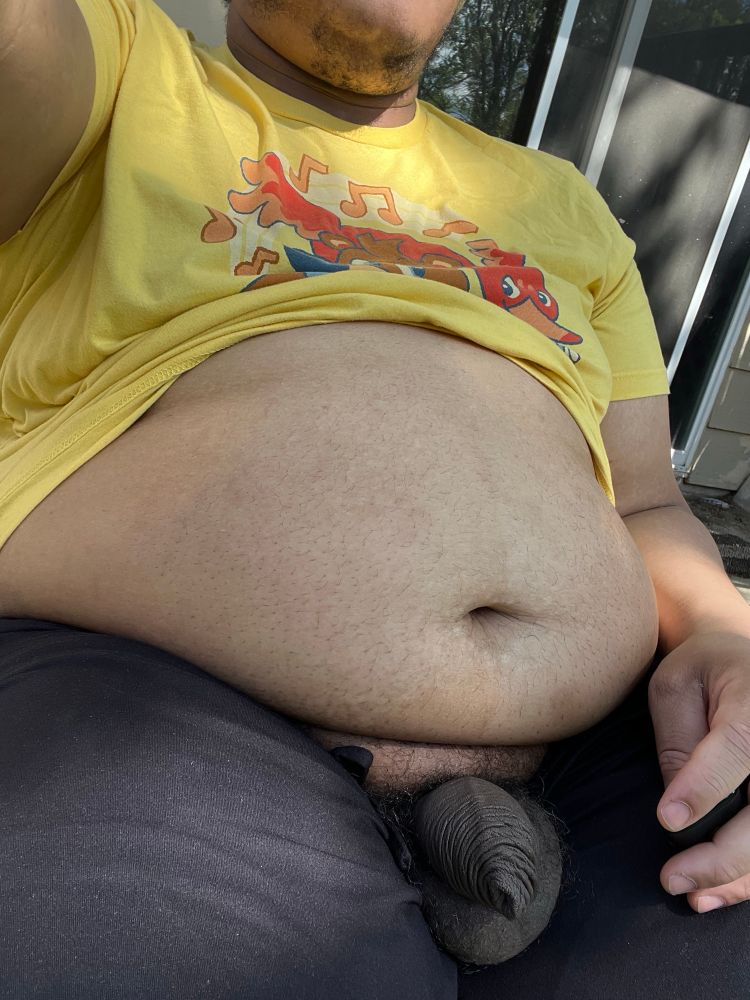 Fat man sitting with his balls out