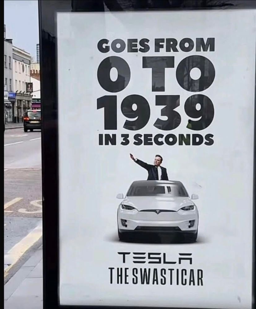 A poster of Elon m’Musk behind a Tesla stating Goes from 0 to 1939 in 3 seconds 