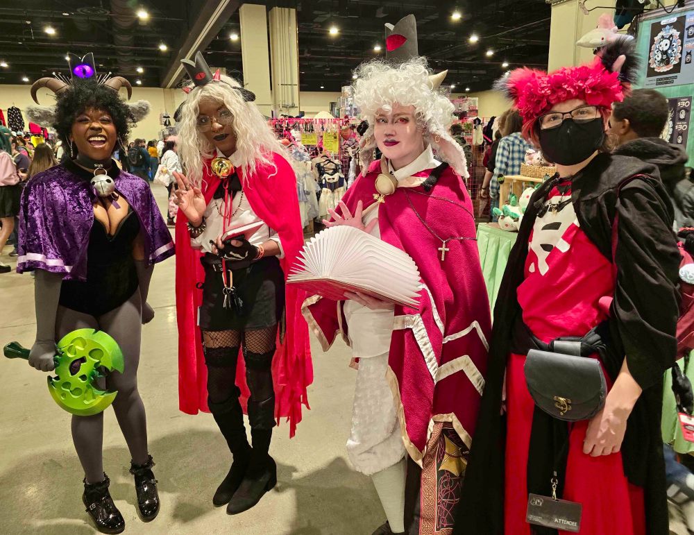 Four cult of the lamb cosplayers, from left to right: goat, lamb, lamb, follower