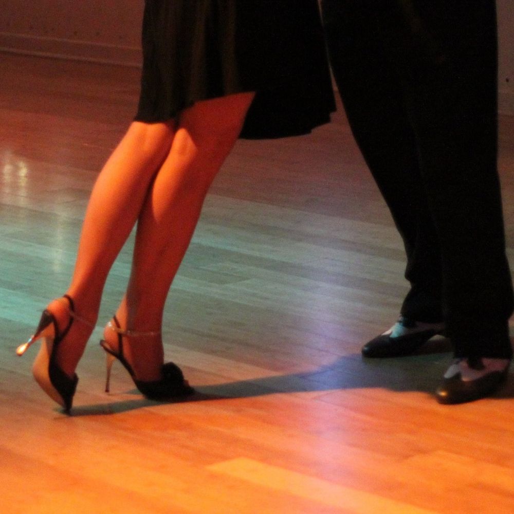 a couple dancing tango pivoting away