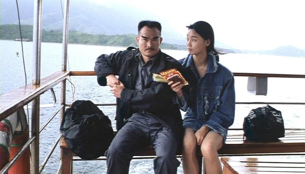 lam ching ying looking cool as hell sitting on a bench in a ferry with an actor playing his niece in a denim jacket and mini skirt. 