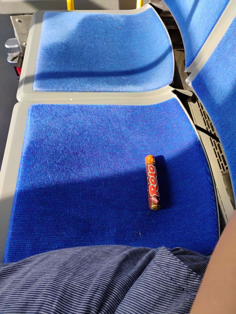 the seat next to me on the bus, occupied by a single roll of rolos, still in their wrapper. 
