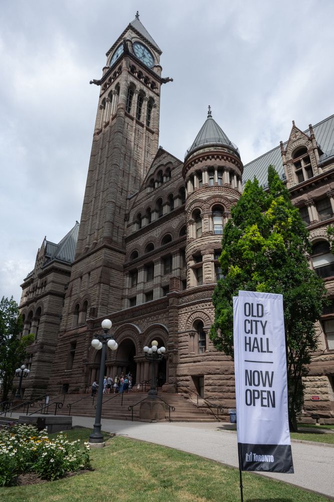 Exterior of Old City Hall, sign reads "Old City Hall Now Open"