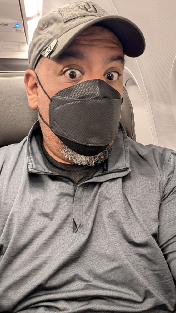 Roadblock, a lucky fool, in a grey pullover, dark gray hat, and kn94 mask. 