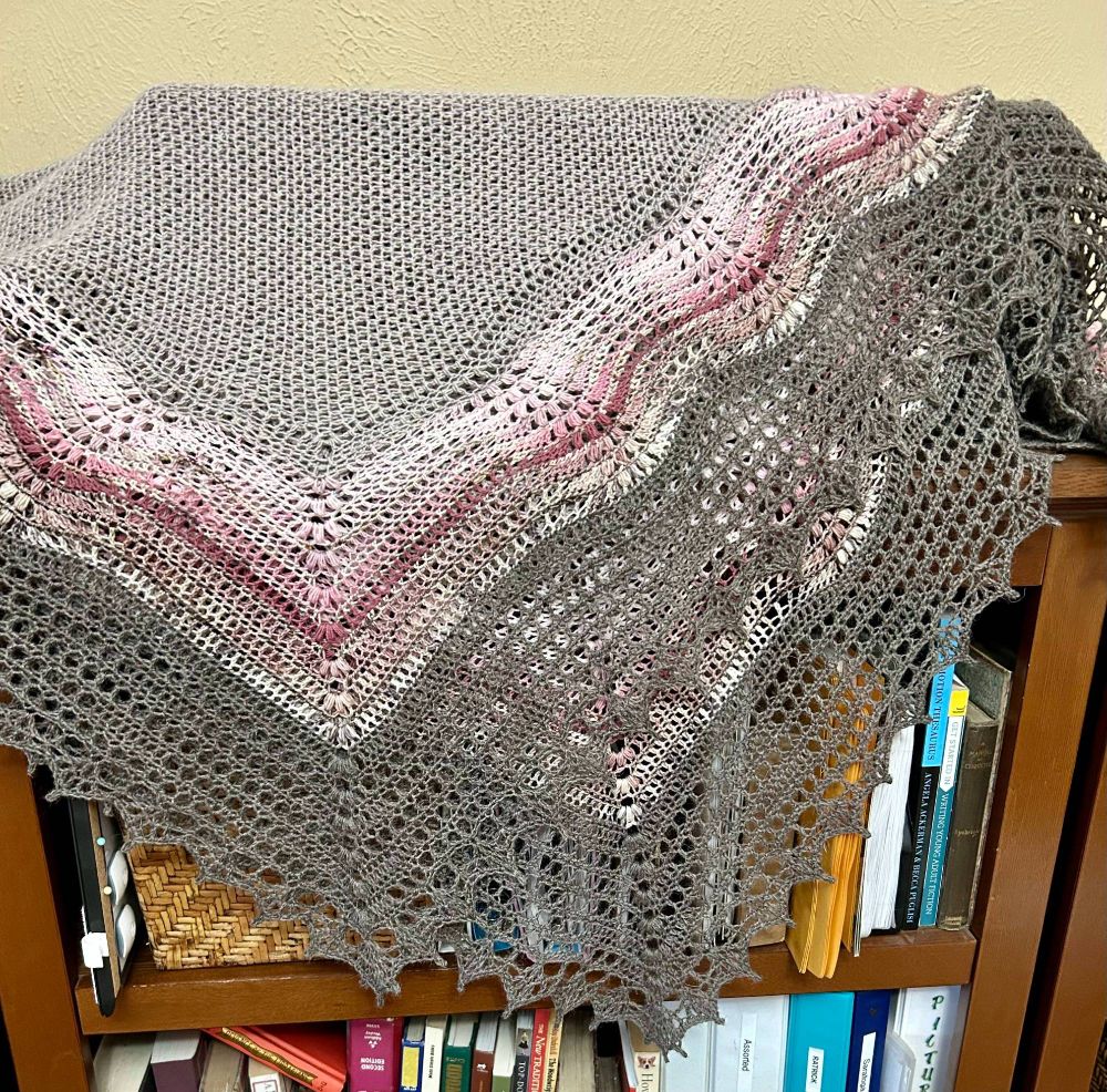 Large square shawl, folded in half along the diagonal. 