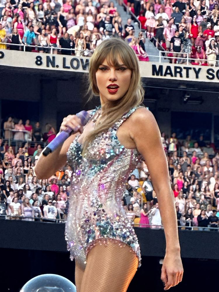 Taylor Swift performing in KC at the eras tour (night 2). She’s wearing the pink and blue lover bodysuit. 