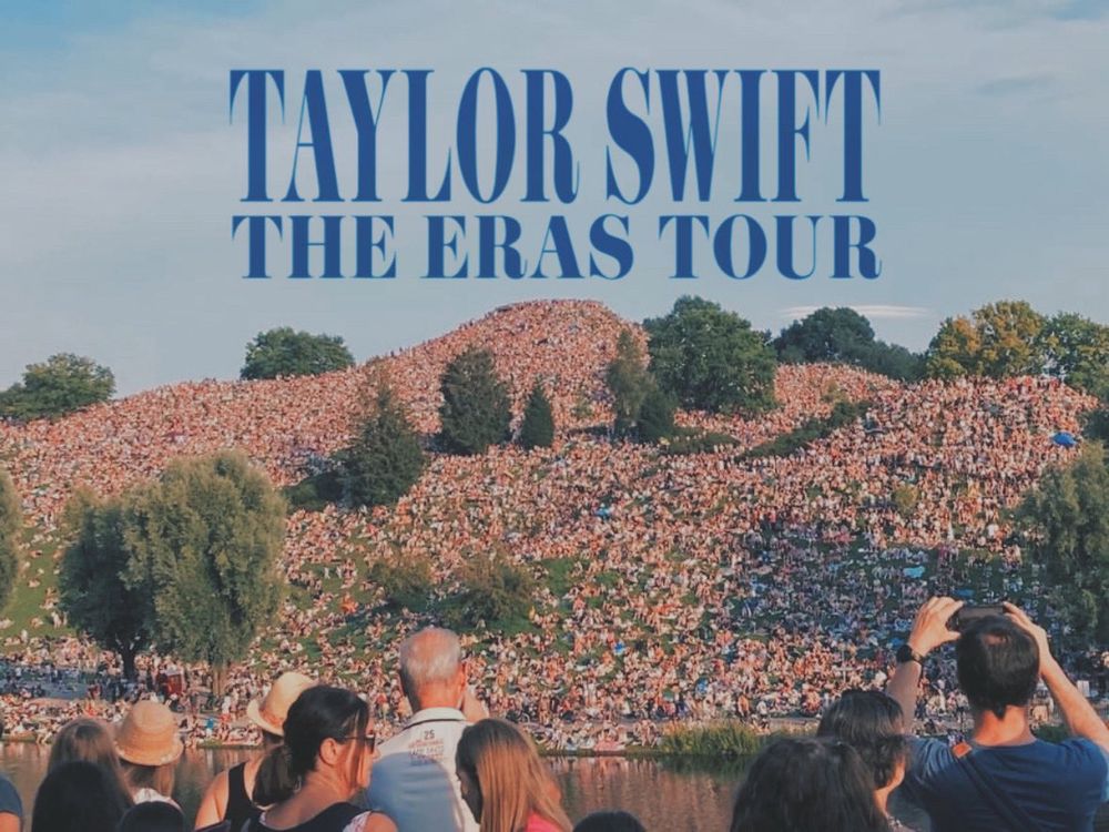 A photo of fans seated on a hill outside the Munich shows. 