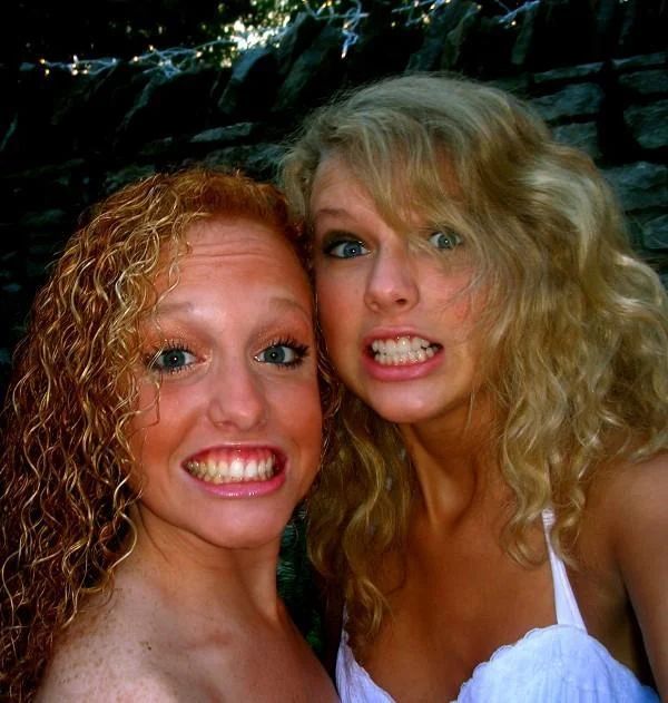 Taylor and Abigail when they were younger. They are making exaggerated smiling faces into the camera. 