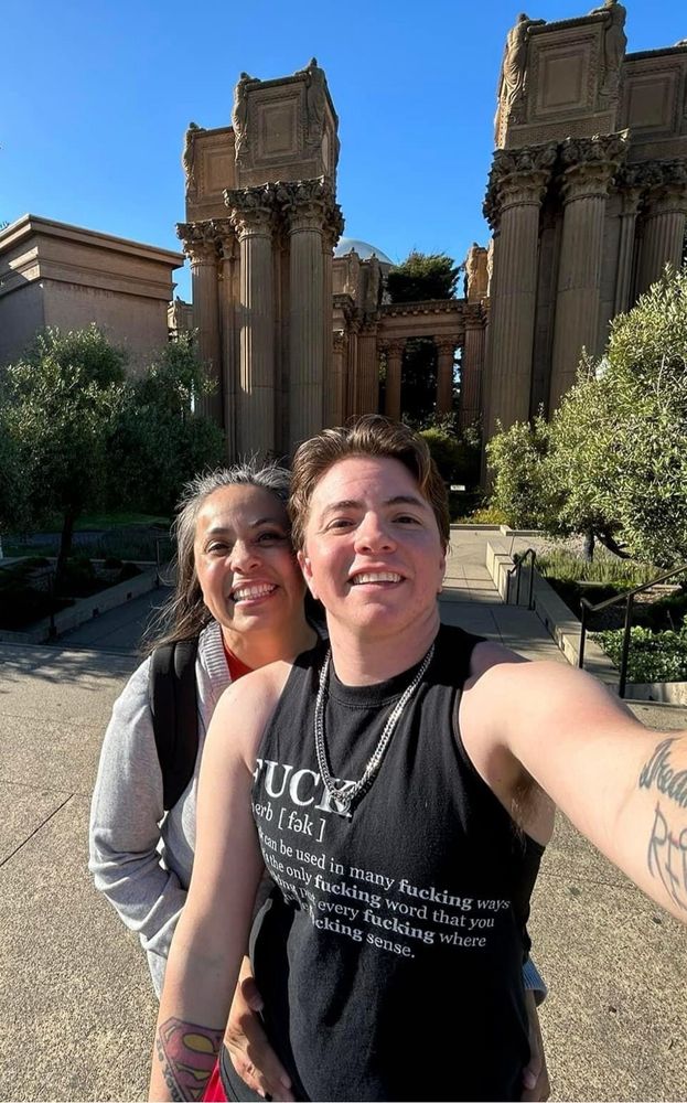 OP posts photo with his Mother while sightseeing in San Francisco before his Top Surgery date wearing a Black cut off shirt with the Word FUCK on it in white and the dictionary definition of the word Fuck while him and his mother smile at the camera. 
