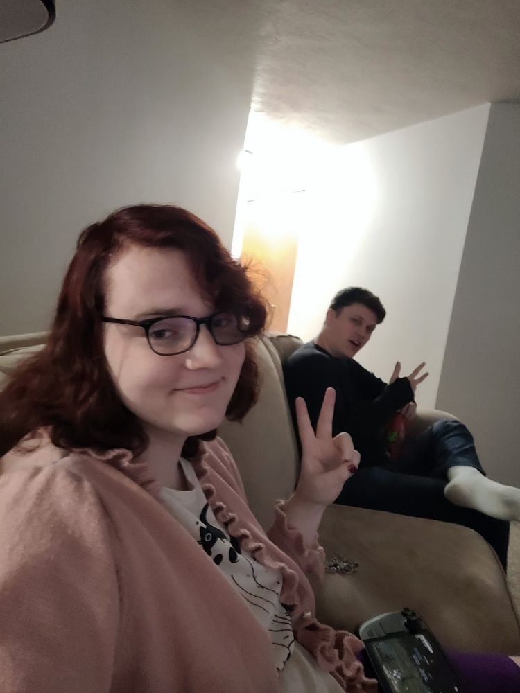 A picture of Silena and her friend sitting on the couch