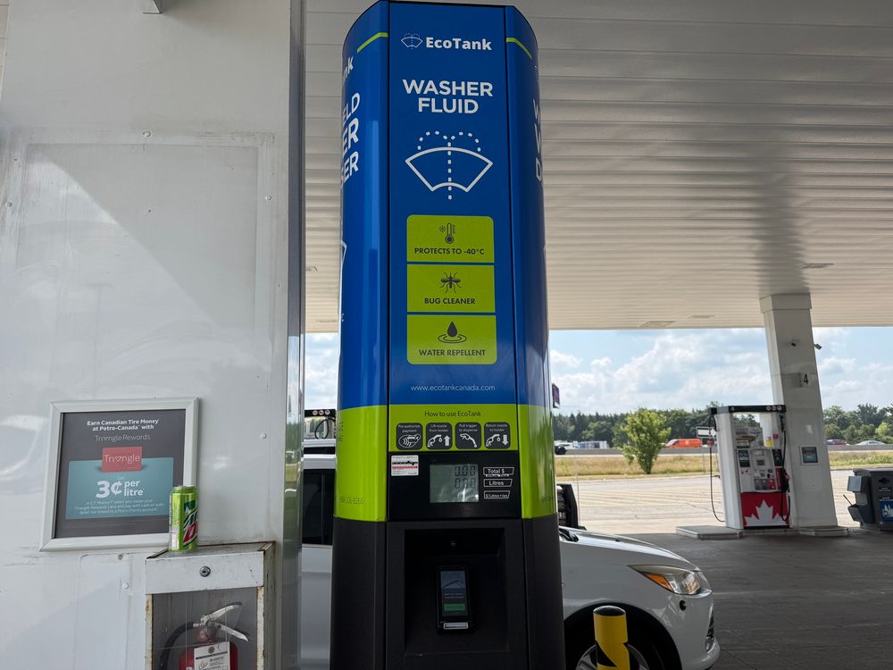 A washer fluid dispenser at a gas station, branded “EcoTank”