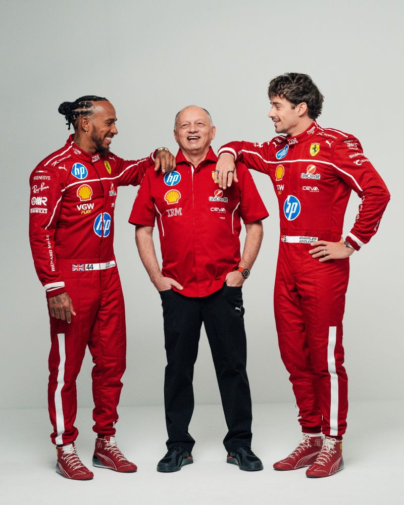Ferrari team: Lewis Hamilton, Fred Vasseur and Charles Lecler posing together. They are smiling laughing either Fred in the middle