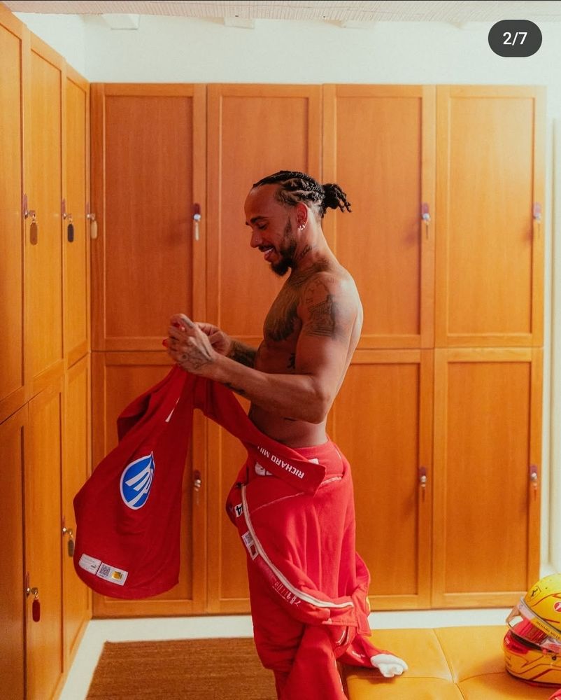 Lewis Hamilton shirtless in red overalls