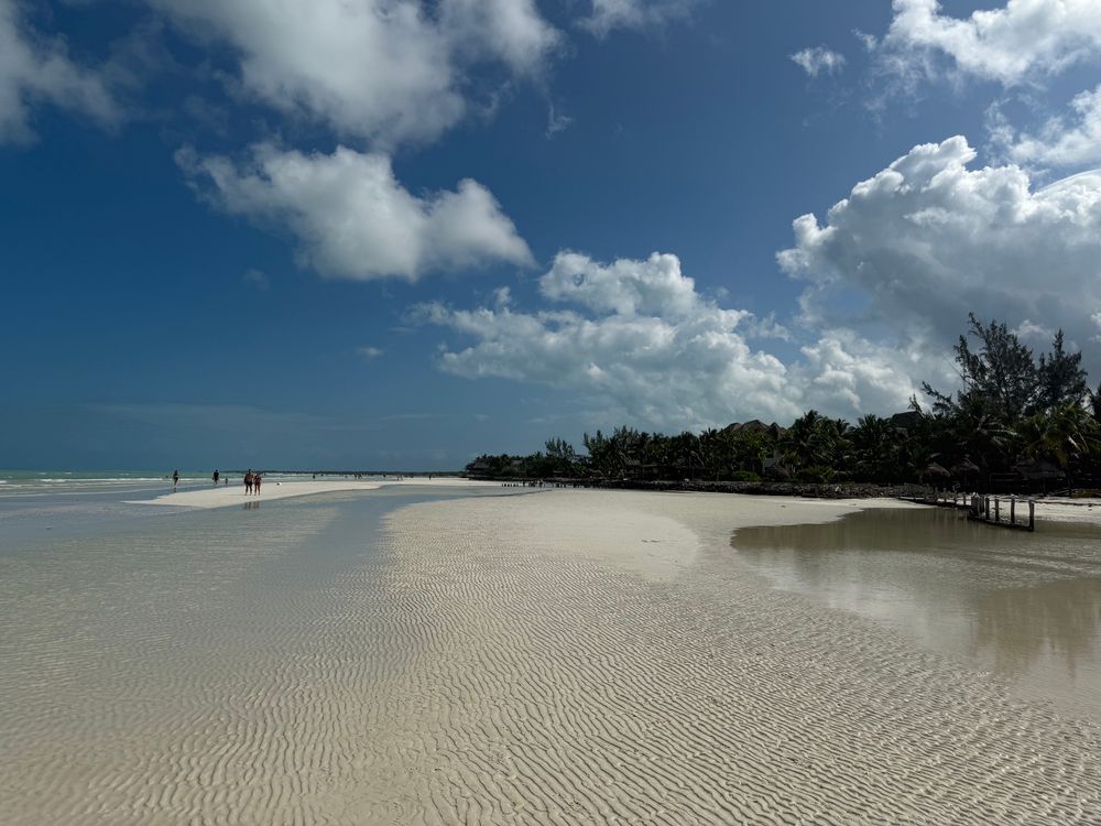 A beautiful beach on an island off the coast of Mexico. Fine white sand, sunny sky, calm water 