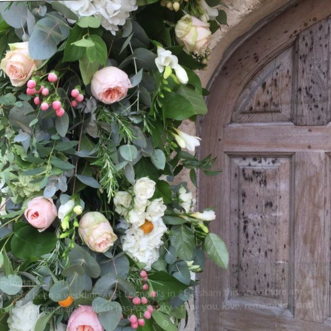 Doorway to St Leonard’s Church festooned with flowers, the day following a wedding