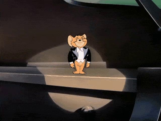 a cartoon mouse in a tuxedo is standing on a ledge