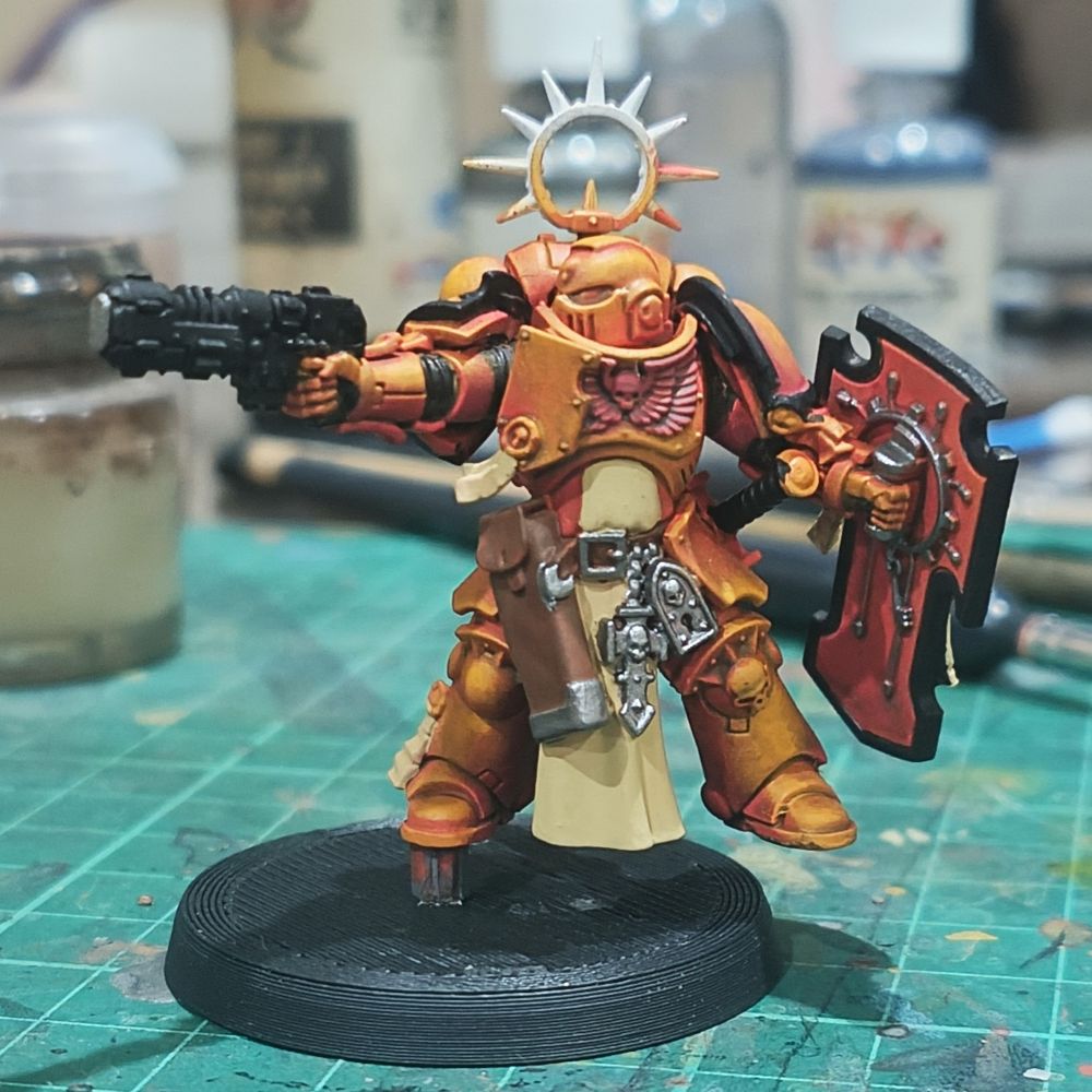 WIP of an Imperial Fists bladeguard (guy with a sword and shield, but has his sidearm out in this case) marine with armor painted up and only missing the metallic details and wax on his many purity seals.