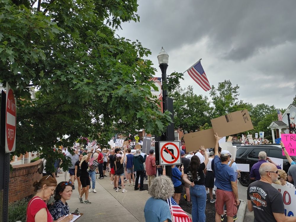 A view down the other side of the protest, just as crowded. Sidewalks are packed with people.
