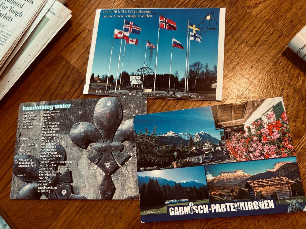 3 postcards on a table.