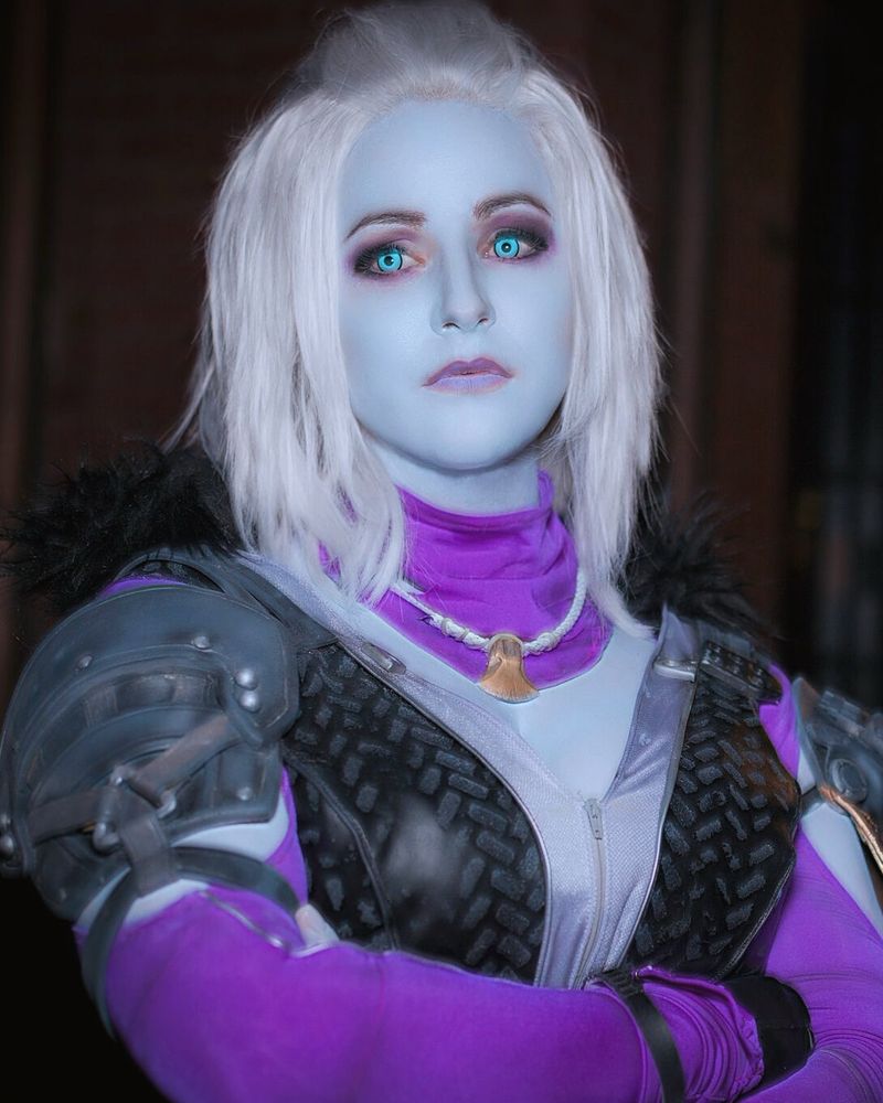 Mara Sov a character from the Destiny 2 video game stands with arms crossed