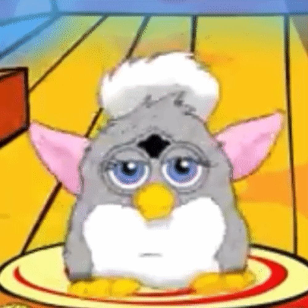 a furby is sitting on a plate with a chef 's hat on .