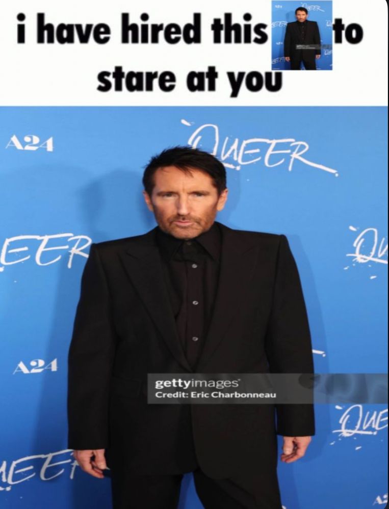 A picture of Trent Reznor staring at the camera with the caption “I have hired this to stare at you” and it’s Trent Reznor staring at you