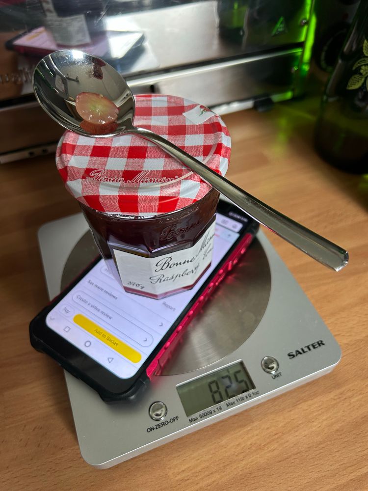 A Ulefone Armor 6 phone, a nearly full jam jar, a dessert spoon and a slice of grape. Weighing in at 825 g on the kitchen scale.

That’s the hefty advertised weight of a Ulefone Armor 34 Pro.