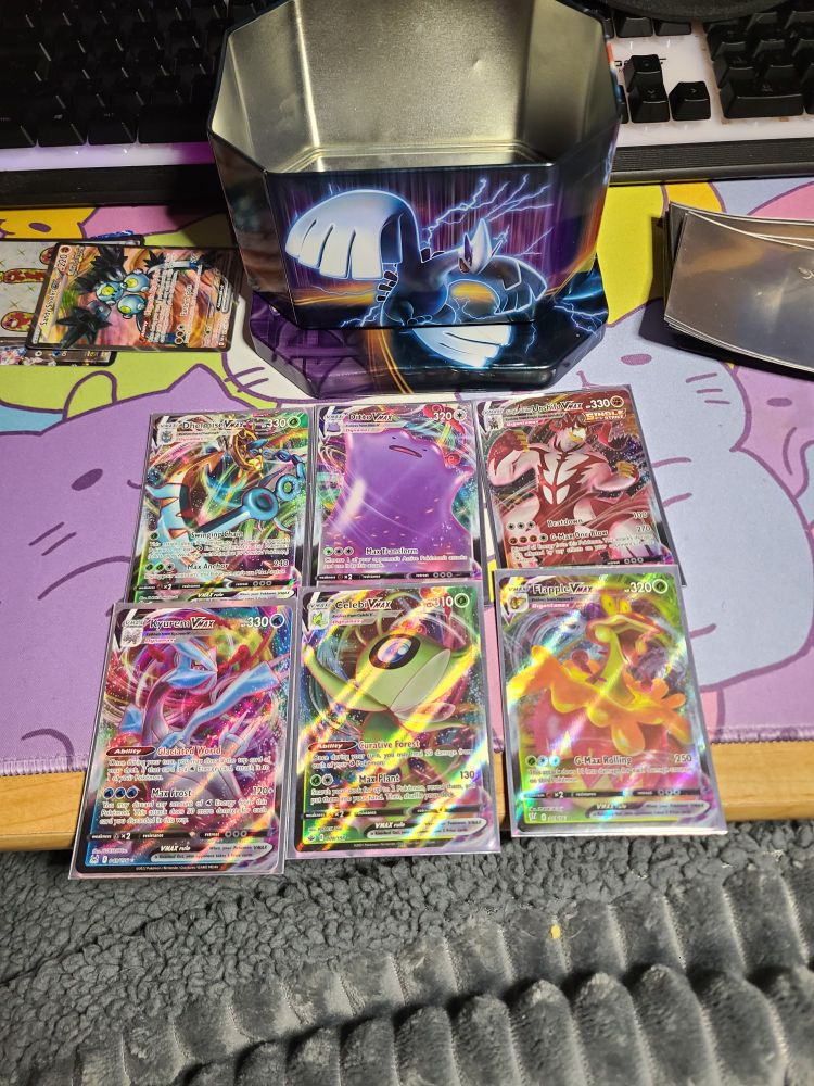 Vmax full art cards from left to right: dhelmise, ditto, urshifu single strike, kyerum, celebi, flapple
