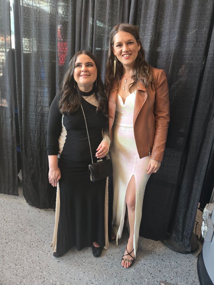 Me in my black sparkly dress and little purse standing by a curtain!