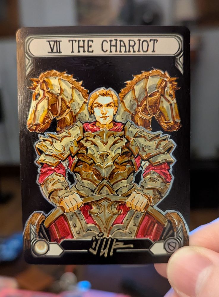 Trading card artist proof or alter of Victor Goldmane on a chariot, flanked on both shoulders by depictions of horses. The design is meant to reference the VII Chariot card in tarot.