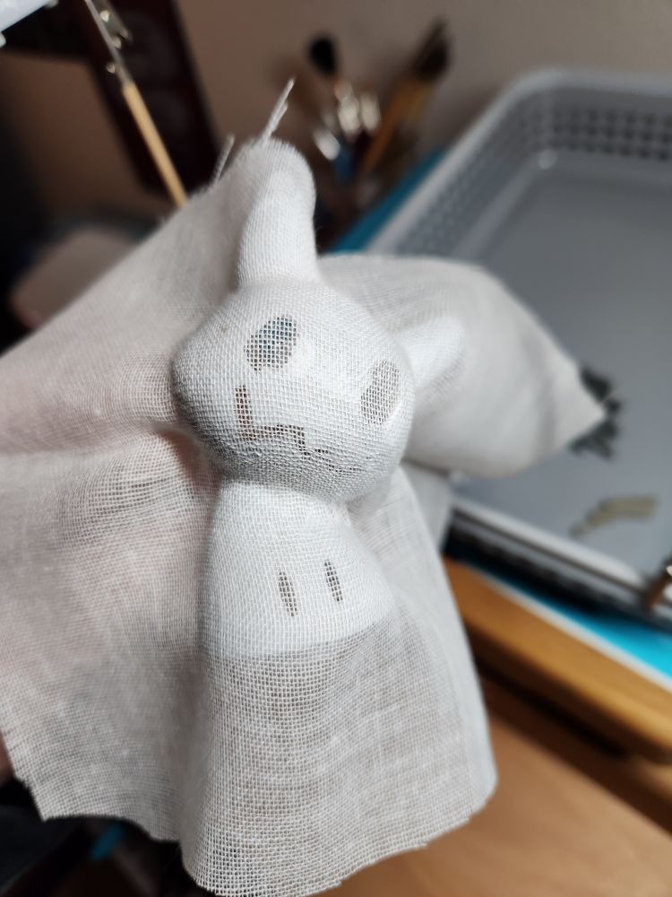 Mimikyu with semi wet modge podge on it with a bunch of cheese cloth stuck on it