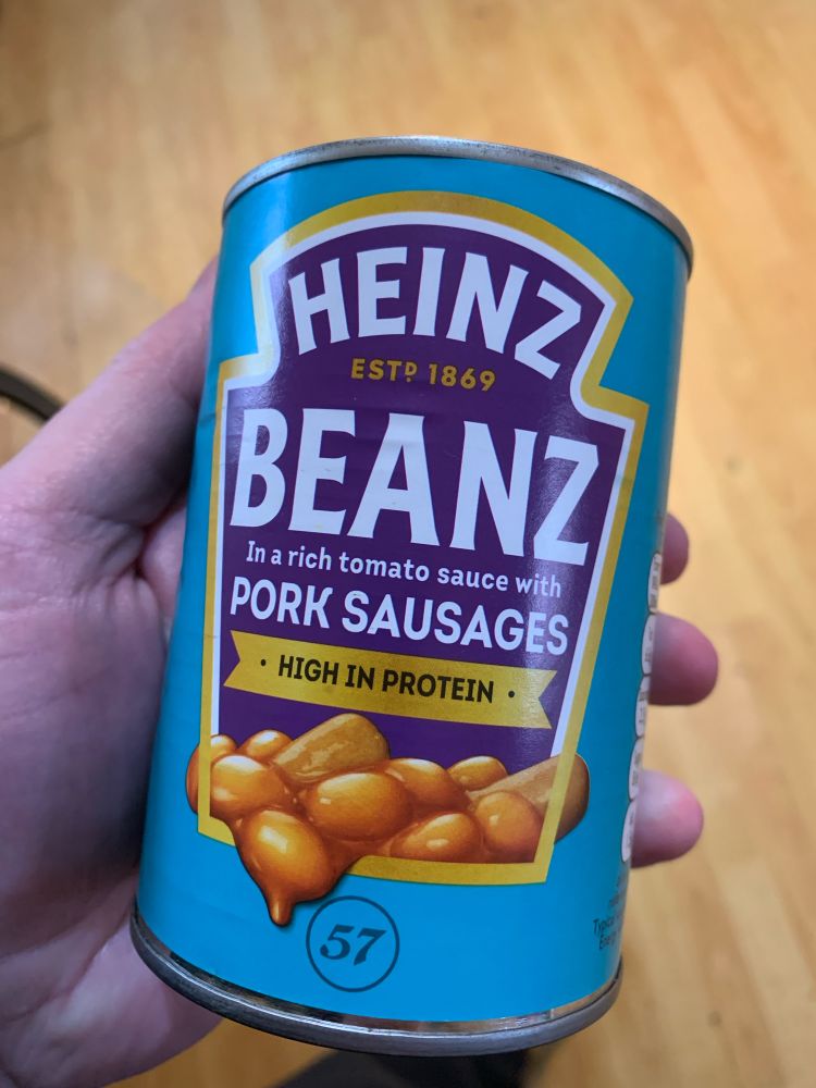 A tin of Heinz beans with mini pork sausages.