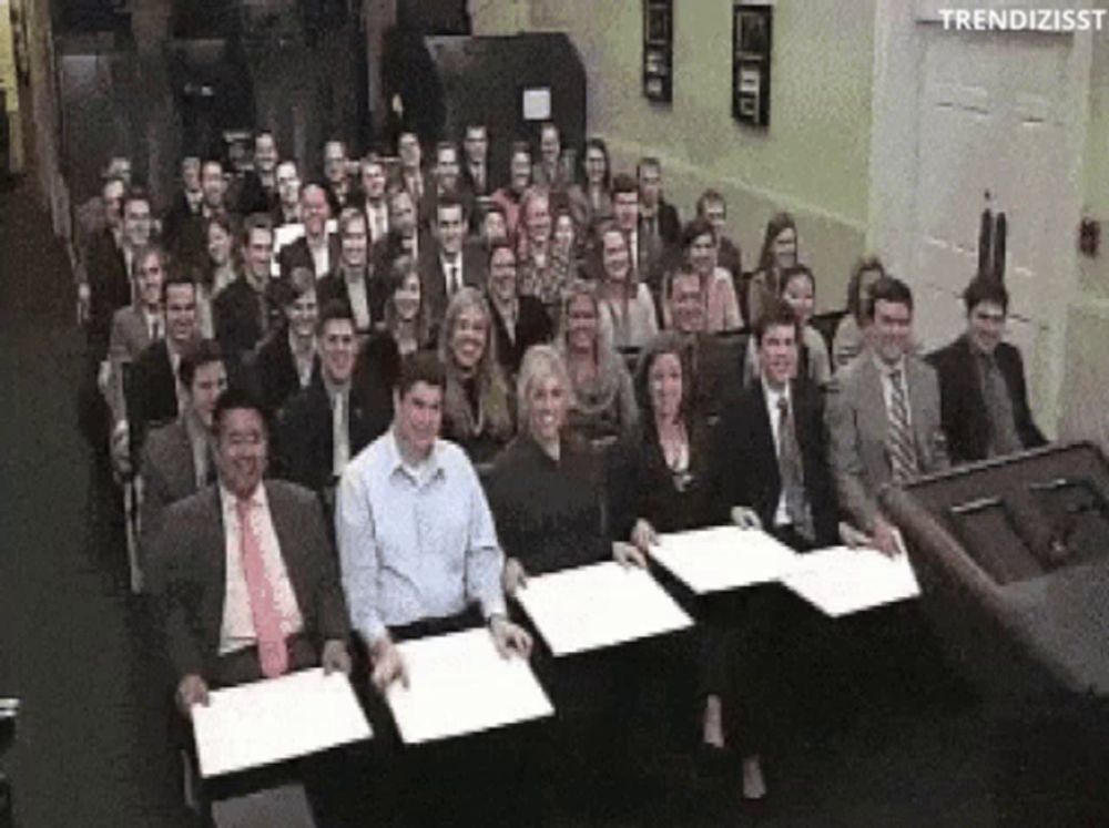 a large group of people are sitting in front of a podium with the words trendizisst on the bottom