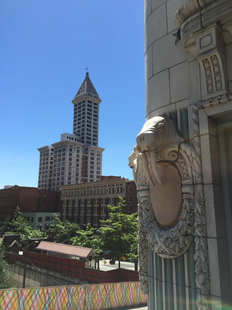 A photo of Seattle’s historic Smith Tower with a walrus detail from the Arctic Club hotel in the foreground