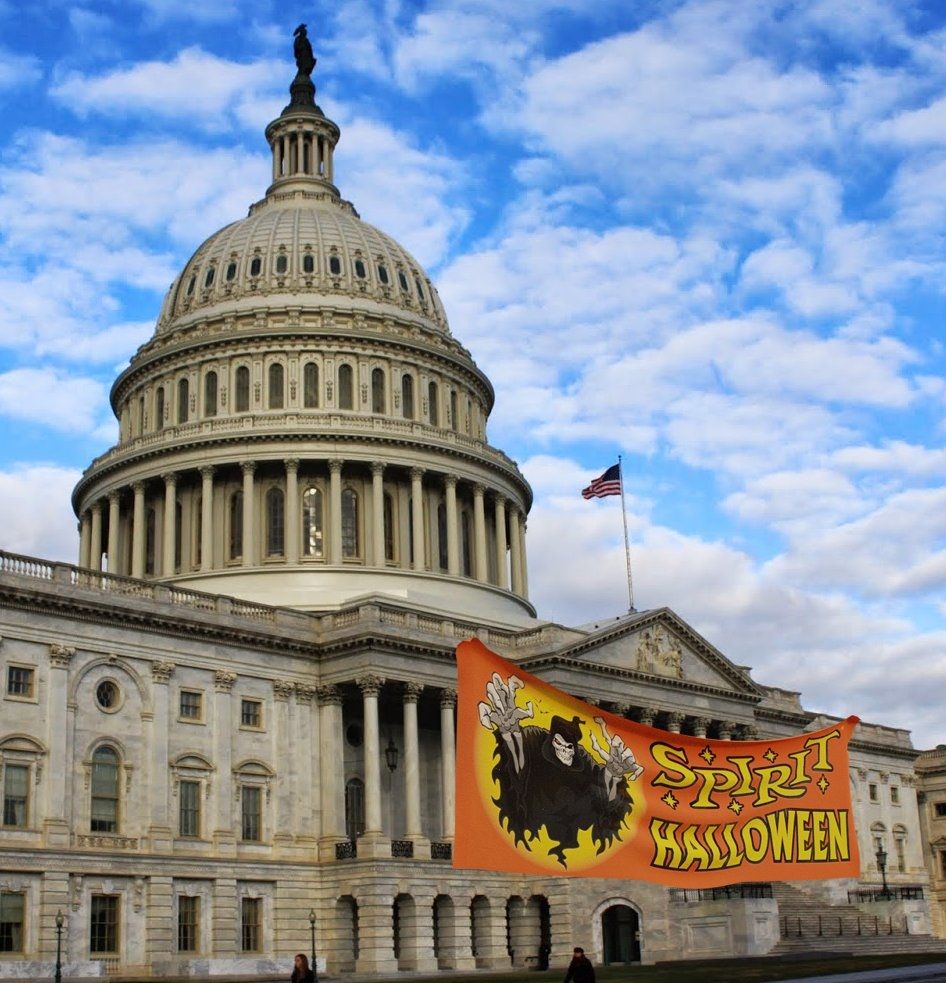 image is a picture of the capitol with a spirit halloween banner out front