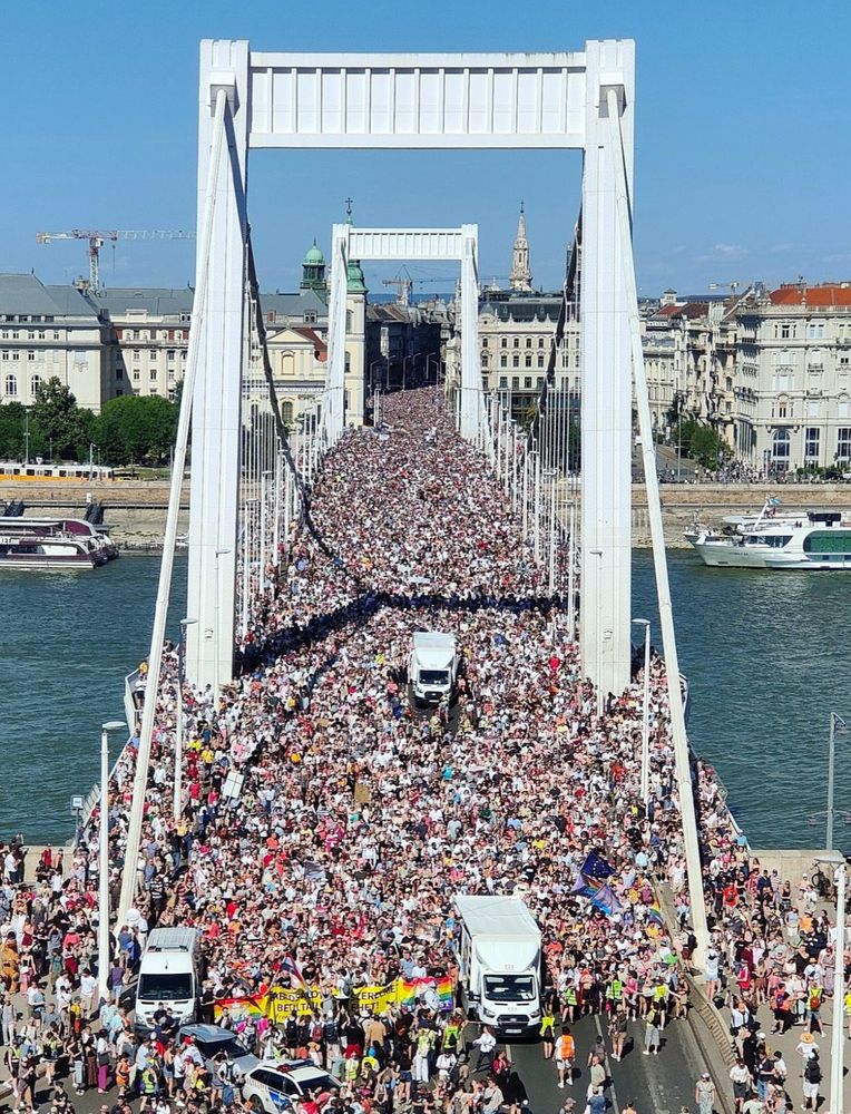 Hundreds of thousands of Pride marchers cross the Elizabeth Bridge in Budapest. The crowd carries on as far as you can see.