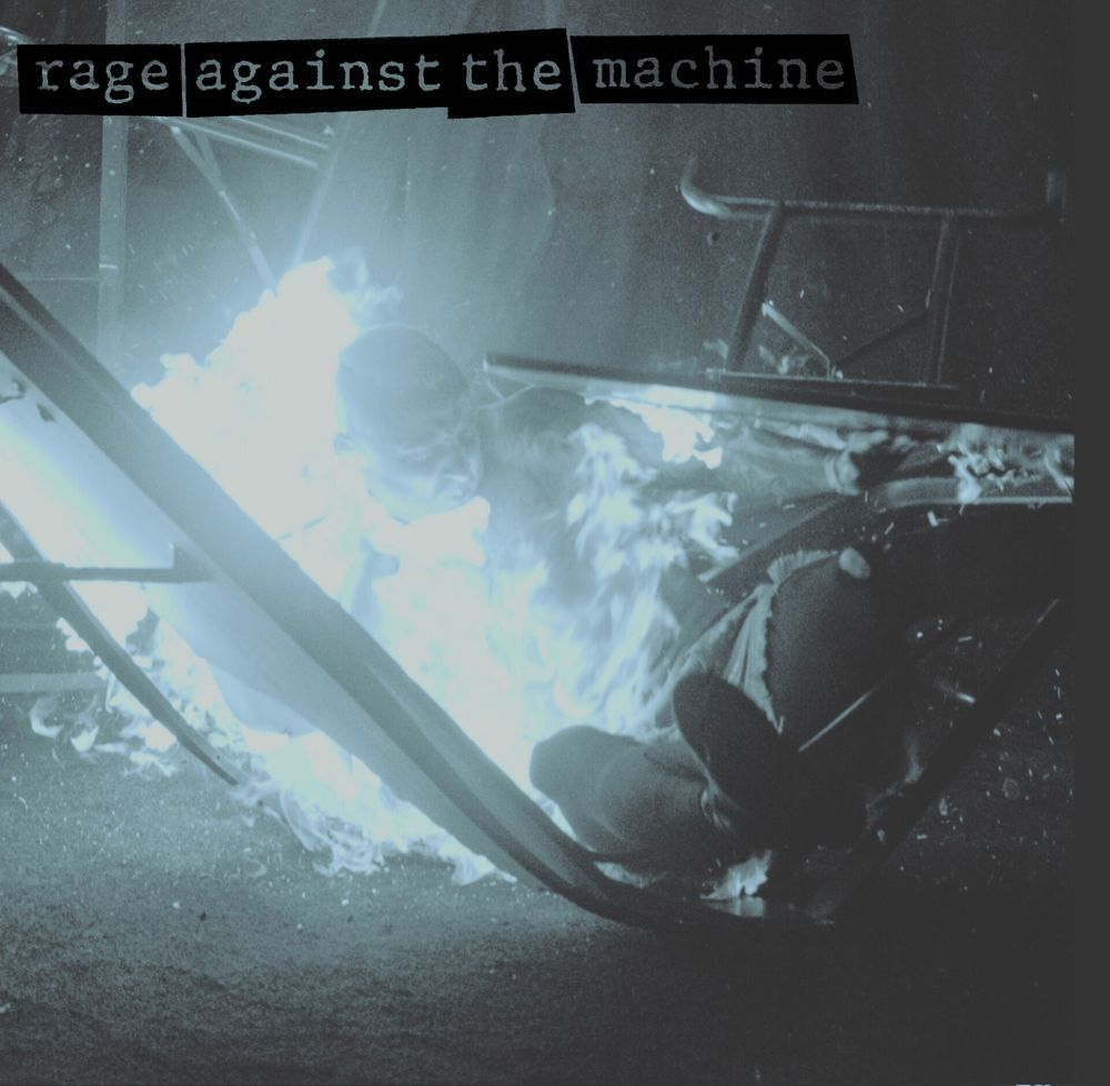 An edited photo of Darby Allin being thrown into a flaming table at AEW Blood and Guts 2025 to look like the cover of Rage Against the Machine's debut album.